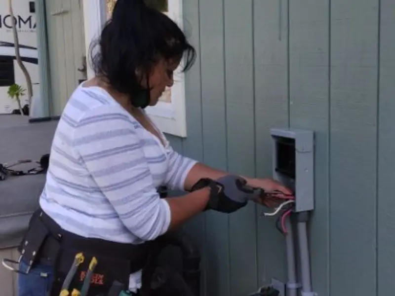 Licensed electrician wiring an exterior subpanel in Eliot